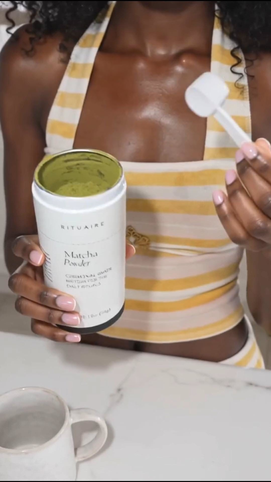 After the Ritual — holding the Rituaire Matcha Powder tub